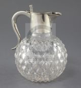 A late Victorian silver mounted cut glass claret jug by John Newton Mappin, with scroll handle and