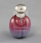 A novelty silver mounted 'Victoria plum' glass scent bottle, with graduated pale violet to red bloom