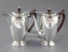A 1940's silver cafe au lait pair by Mappin & Webb, of cylindrical form, on stepped circular foot,