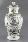 A Chinese famille verte vase and cover, late 19th century, finely painted with a rockwork garden