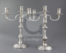A pair of late 1970's silver two branch three light candelabra by William Comyns & Sons Ltd, with