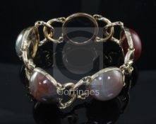 An early 20th century gold and cabochon agate bracelet, set with five assorted agate stones, 20cm.