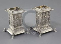 An ornate pair of George V silver dwarf candlesticks by Wakely & Wheeler, of rectangular form,