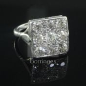 A 1940's/1950's platinum and nine stone diamond set tablet ring, size N.