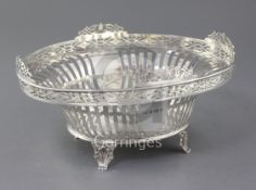 A George V pierced silver oval fruit bowl, by Latham & Morton, with pierced border, on shell