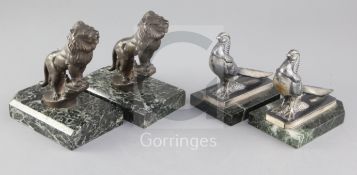 Maurice Frécourt. Two pairs of Art Deco bronzed and silvered metal bookends, roaring lions and Asian