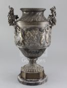 A 19th century French bronze urn, with vineous handles and decorated with a band of putto, goats and