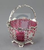 A Victorian pierced silver sugar basket by James & Nathaniel Creswick, with scrolling decoration,