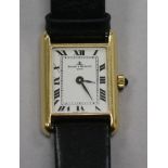 A lady's 18ct gold Baume & Mercier rectangular dial manual wind wrist watch.