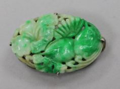 A 19ct century carved jadeite plaque, in later Chinese white metal brooch mount, 36mm.