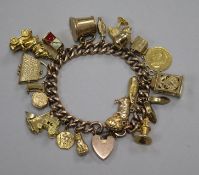 A 9ct gold charm bracelet hung with twenty two assorted mainly 9ct gold charms including yacht,