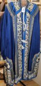 A Chinese silk embroidered robe c.1920's, embroidered with panels of birds and flowers on royal blue