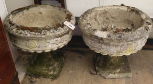 Two reconstituted stone pedestal campana urn-shaped planters W.46cm approx.