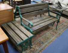 A pair of green painted cast iron and teak garden benches and two tables W.125cm table W.122cm and