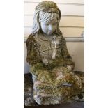 A reconstituted stone garden stature modelled as a seated young girl reading a book W.50cm approx