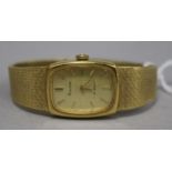 A Bulova ladies' 18ct gold wristwatch with gilt dial and baton numerals on textured tapered flexible