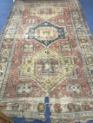 A Caucasian red and blue ground carpet 320 x 190cm approx.