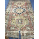 A Caucasian red and blue ground carpet 320 x 190cm approx.