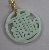 A carved jadeite pendant, on a 9ct gold chain.