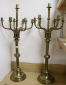 A pair of Victorian brass seven-light candlesticks, with detachable candle arms, H 82cm