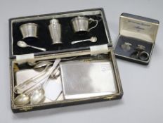 A three-piece silver cruet, cased, two silver cigarette cases, sundry spoons, etc., together with