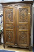 A 19th century French walnut armoire with gilt carving W.150cm.