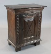 A 17th century style oak side cabinet, with single fielded panelled door and stile feet, W.74cm H.