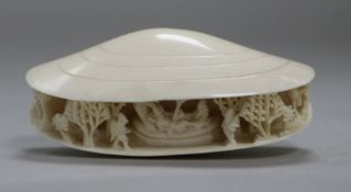 A Chinese carved ivory 'oyster shell' with interior decoration of a reclining couple in a woodland