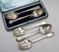 A pair of George III silver serving spoons, cased and three tablespoons, the serving spoons with