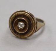A high carat yellow metal and diamond set target ring, size M/N.