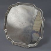 A presentation silver shaped square salver, on four bun feet, inscribed, London 1911, Makers: