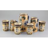 A collection of Fulham pottery stoneware vessels, c.1902, comprising three jugs and four beakers,