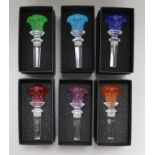 A set of six Rosenthal for Versace vari coloured Medusa head glass bottle stoppers