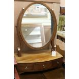 A Regency bow front toilet mirror W.42cm