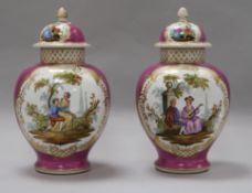 A pair Helena Wolfsohn, Dresden pink ground vases and covers, late 19th century, each painted with