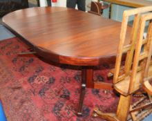 Kofod Larsen for Faarup Mobelfabrik, Denmark, a rosewood-veneered extending dining table, with two