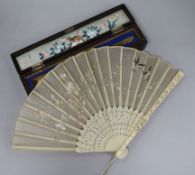 A 19th century Chinese ivory and embroidered silk fan in a lacquer box.