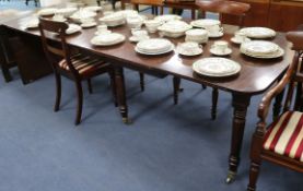 A late Georgian mahogany extending dining table, with three additional leaves, on turned supports