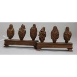 A set of six Chinese peach stones carved as immortals and a monkey, rosewood stands, each approx.