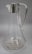 An Edwardian silver-mounted cut glass claret jug, the jug of plain tapered bulbous form with star-