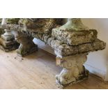 A reconstituted stone shaped garden bench W.108cm