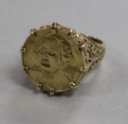 A 9ct gold ring with inset U.s. gold bi-centennial coin, size M.