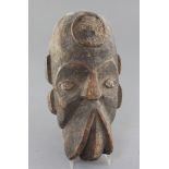 An African carved wood mask, with traces of applied decoration, 32cm