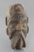 An African carved wood mask, with traces of applied decoration, 32cm