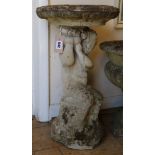 A reconstituted stone birdbath and pedestal