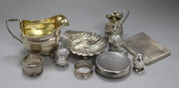 A Georgian silver and silver-gilt cream jug and sundry small silver items, including a shell