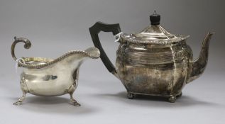 A small silver teapot and a silver cream boat, the teapot of shaped oval reeded form, with gadrooned