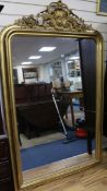 A 19th century French giltwood and gesso wall mirror, with moulded frame and foliate scroll crest,