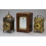 A cased carriage clock and two small lantern clocks