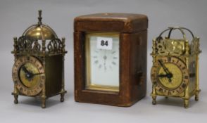 A cased carriage clock and two small lantern clocks